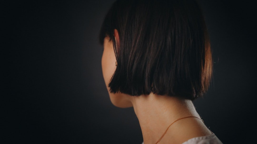 Woman with short swept-back hair and soft volume at the front