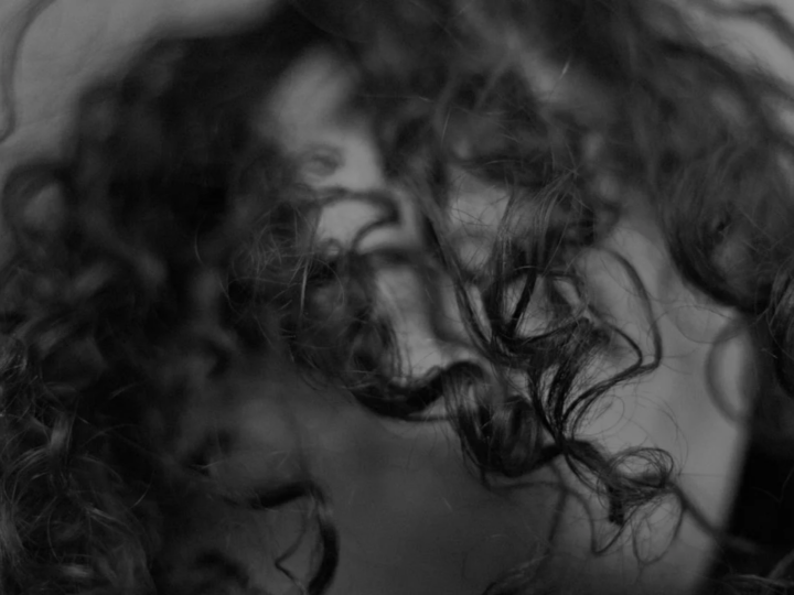 Woman with natural textured hair and soft air-dried movement