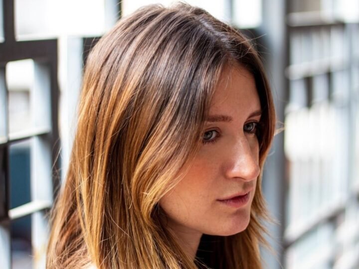 Brunette hair with soft amber highlights creating warm dimensional brightness