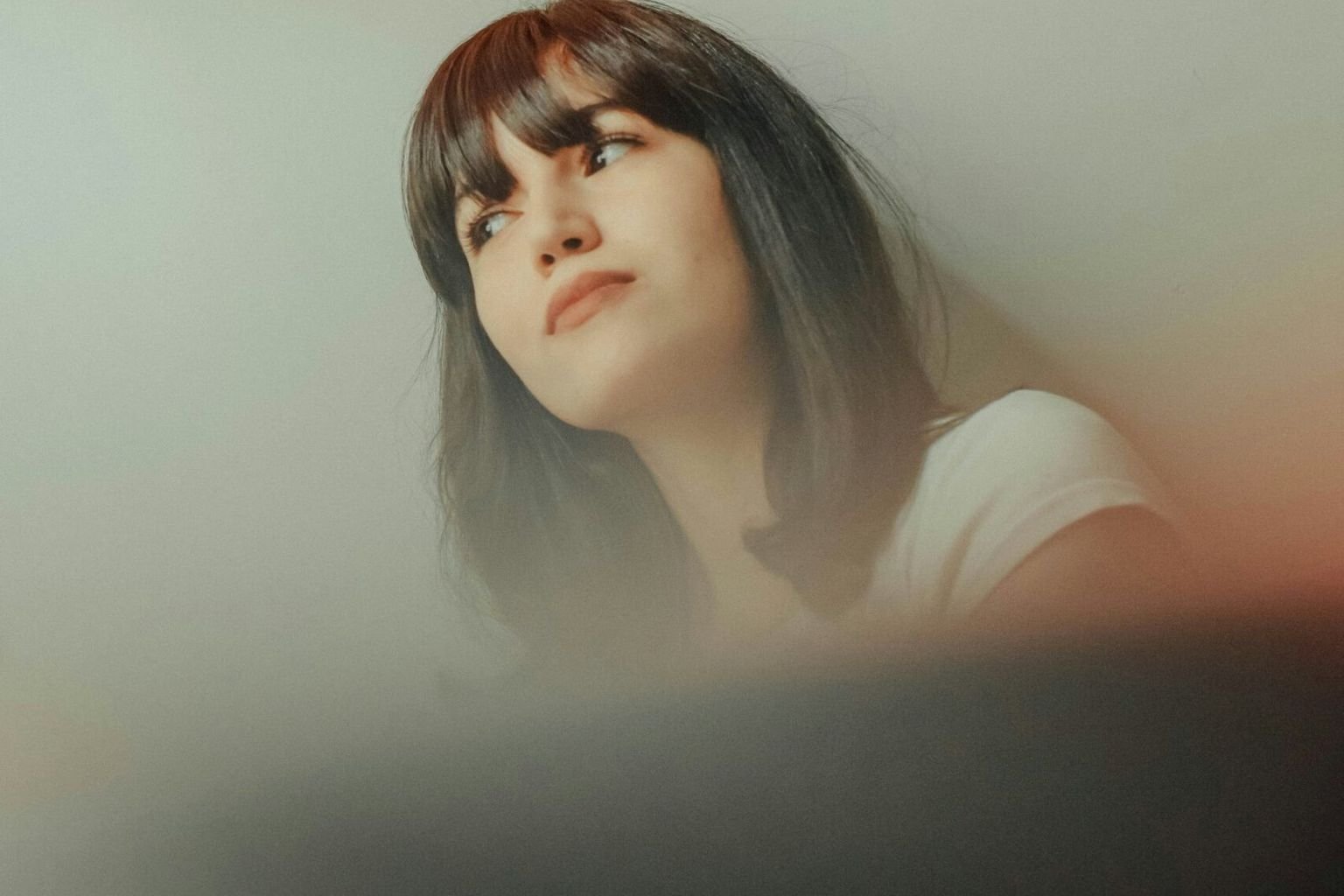 Woman with short dark hair and a full fringe