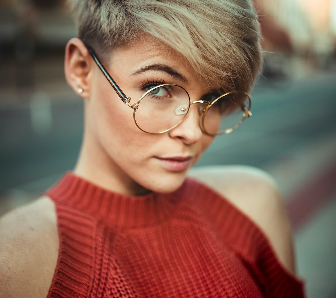 Woman with a short layered bixie-style haircut showing soft volume through the crown