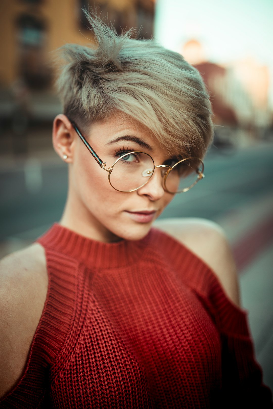 Woman with a short layered bixie-style haircut showing soft volume through the crown