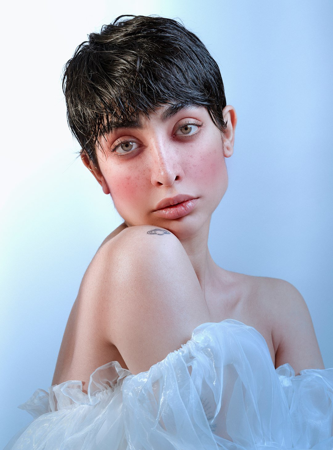 Woman with a short textured haircut illustrating a more piecey bixie shape