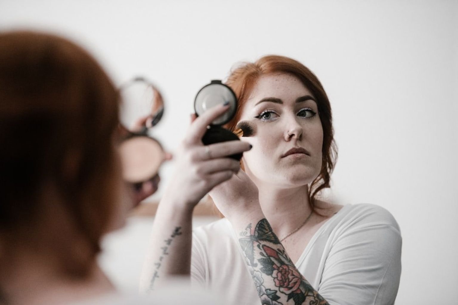 Soft blush placed high on the cheeks for lifted color without heavy contour