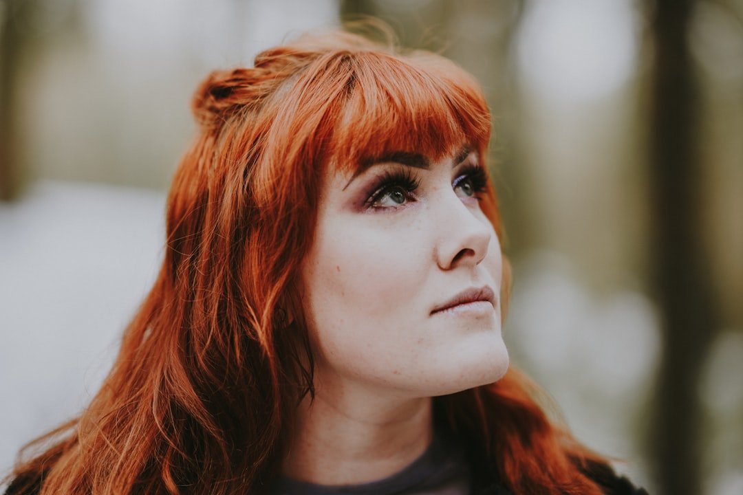 Woman with warm red-copper hair color in natural light