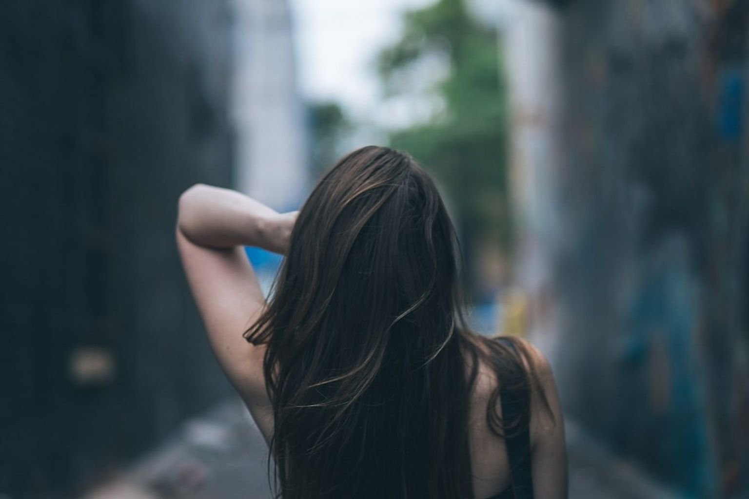 Long glossy dark chocolate brunette hair with reflective tonal depth in natural light