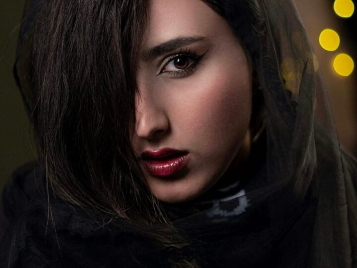 Deep berry lip color paired with restrained natural-looking face makeup