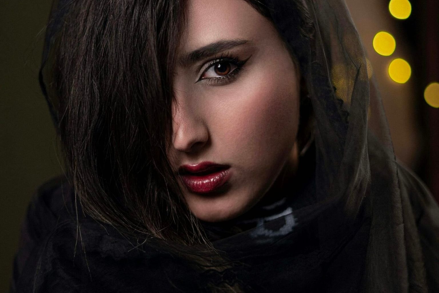 Deep berry lip color paired with restrained natural-looking face makeup