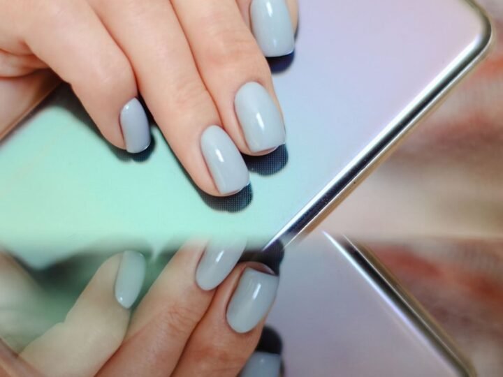 Denim-blue manicure with a reflective chrome metallic finish