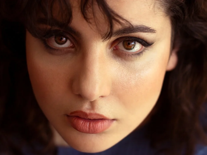 Close-up portrait with softly defined espresso-brown eyeliner and neutral eye makeup