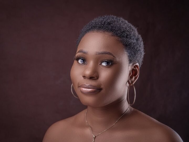 Portrait with smooth hair framing the face and silver hoop earrings