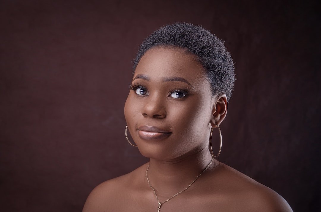 Portrait with smooth hair framing the face and silver hoop earrings