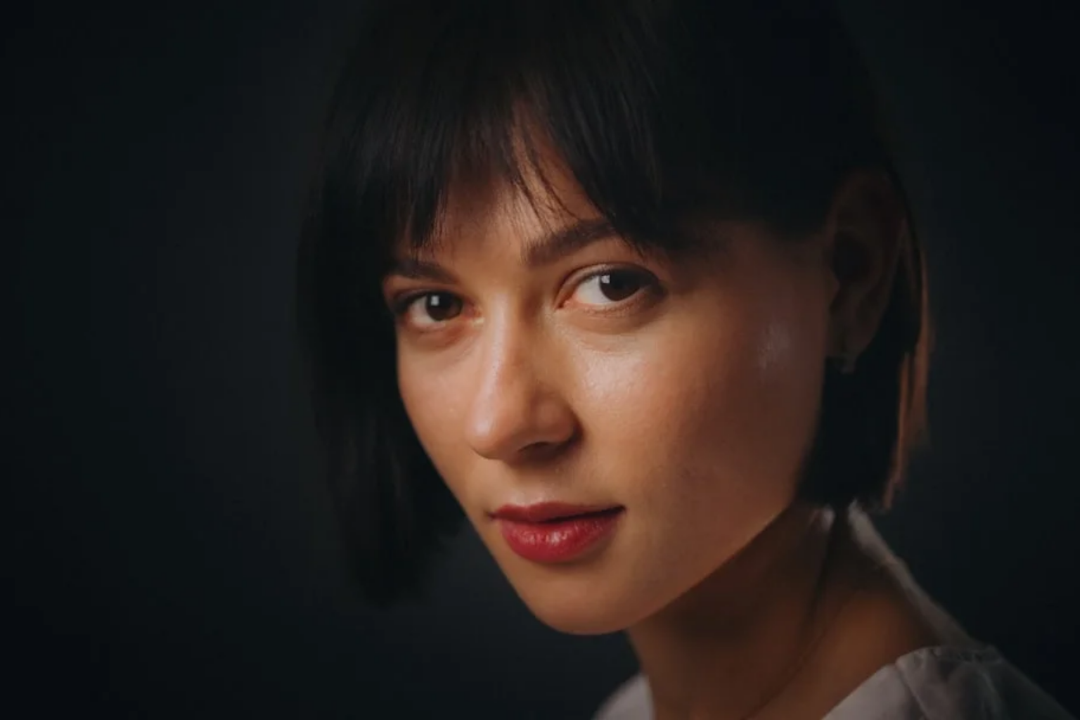 Woman with a short layered haircut at a longer pixie grow-out length