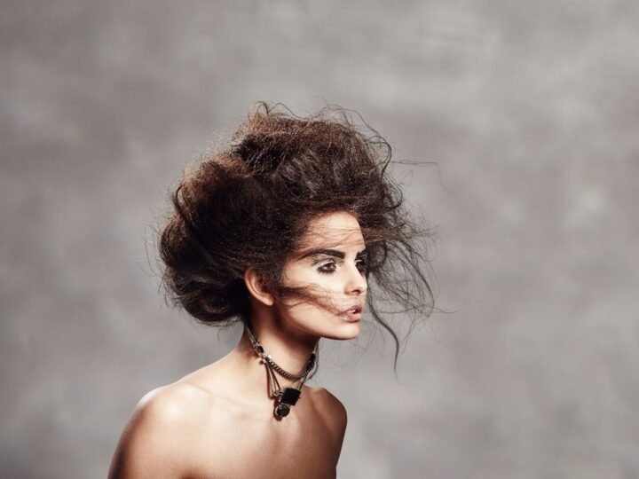 Fashion portrait with styled hair and visible face-framing detail