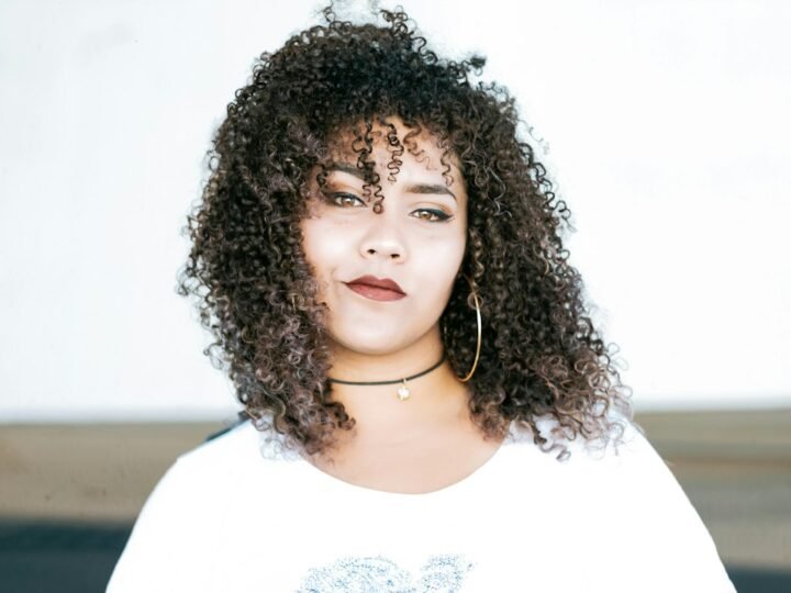 Portrait showing natural hair texture and a clean modern shape