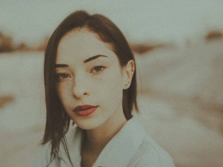 Portrait with defined lip color illustrating a polished lipstick finish