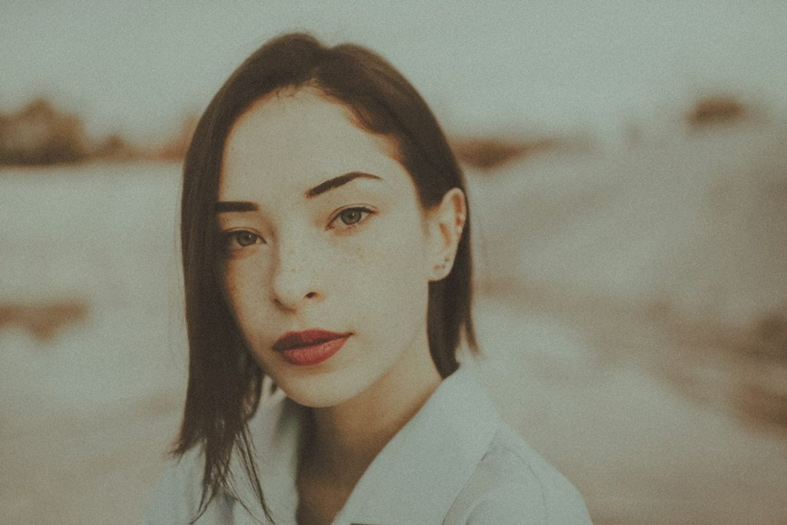 Portrait with defined lip color illustrating a polished lipstick finish
