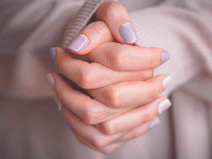 Close-up of manicured hands with a polished finish