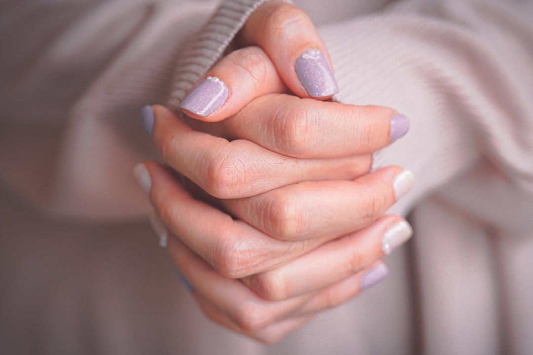 Close-up of manicured hands with a polished finish