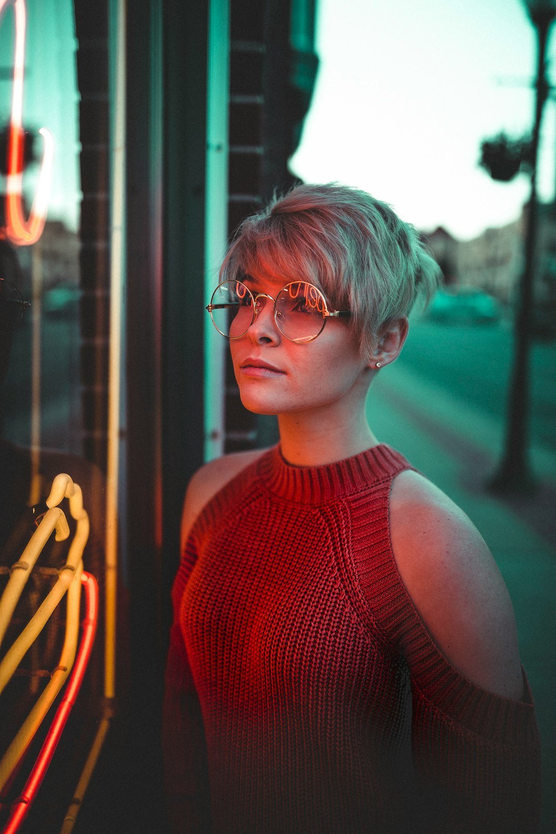 Woman with a short pixie-style haircut showing a soft fringe and compact shape