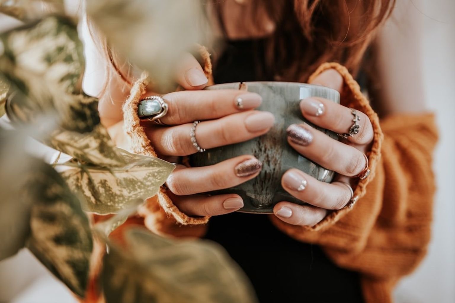 Warm pumpkin-cider manicure in a rusty orange-brown shade with a glossy finish
