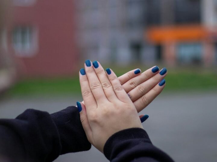 Short natural nails with a glossy saturated sapphire-blue manicure