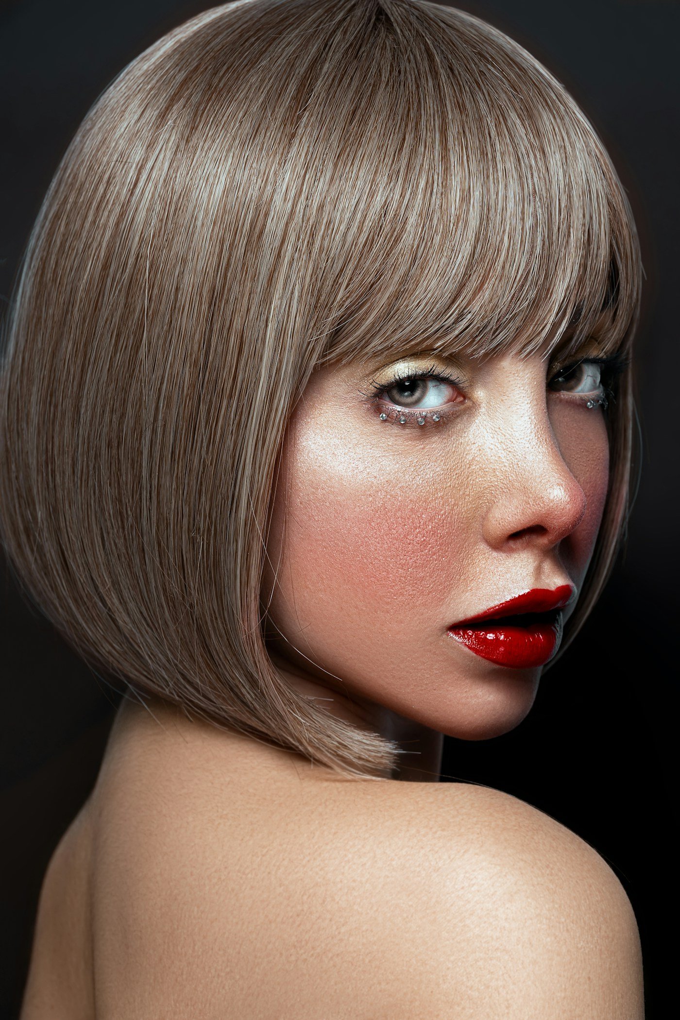 Woman with a short bob haircut showing a defined jaw-length silhouette and face-framing shape