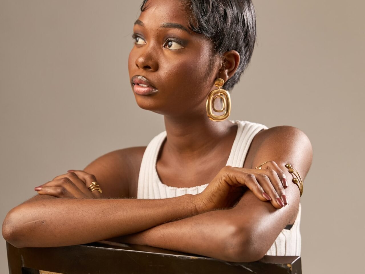 Woman with a short layered hairstyle showing soft movement around the crown and sides