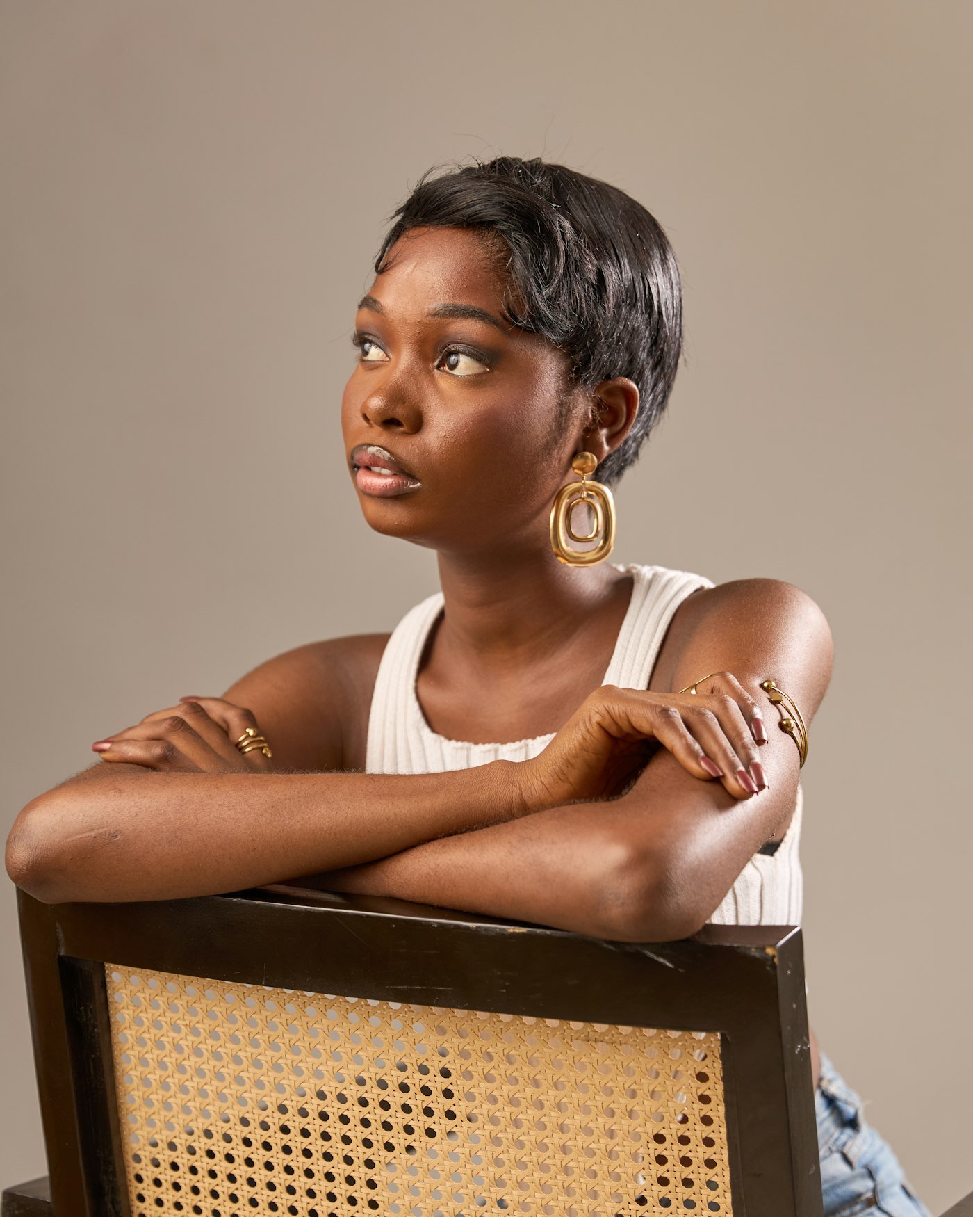 Woman with a short layered hairstyle showing soft movement around the crown and sides