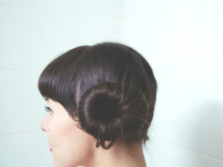 Soft low chignon with a loose polished finish and gentle movement around the head