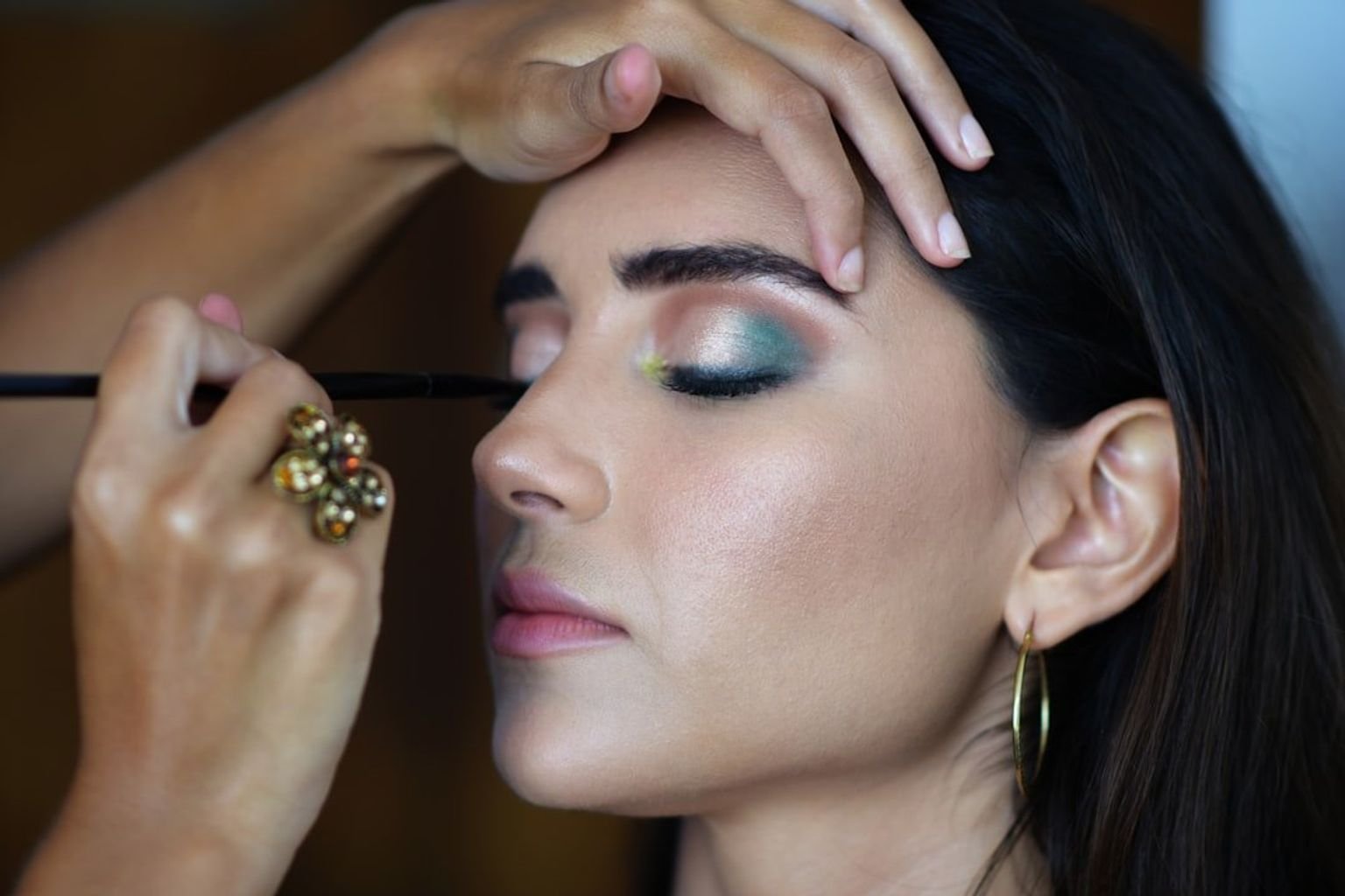 Soft smoky eye makeup with diffused brown-toned depth around the lash line