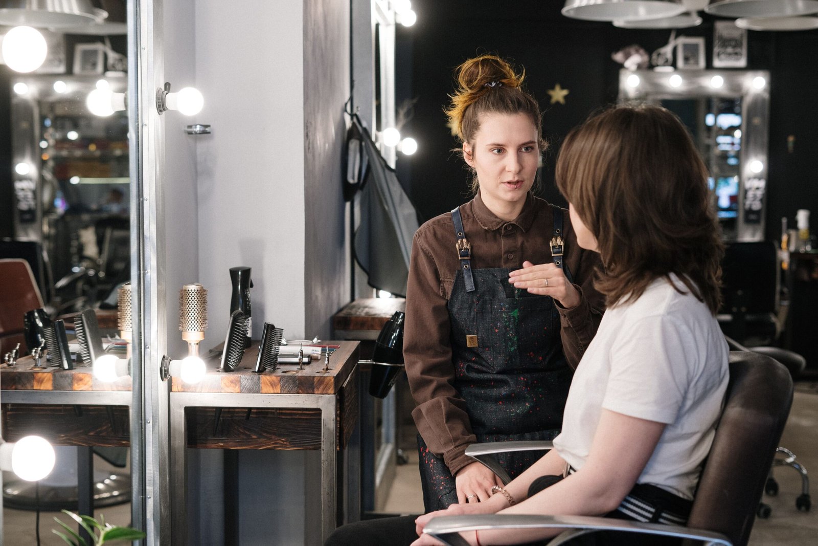 Stylist and client discussing a haircut during a salon consultation