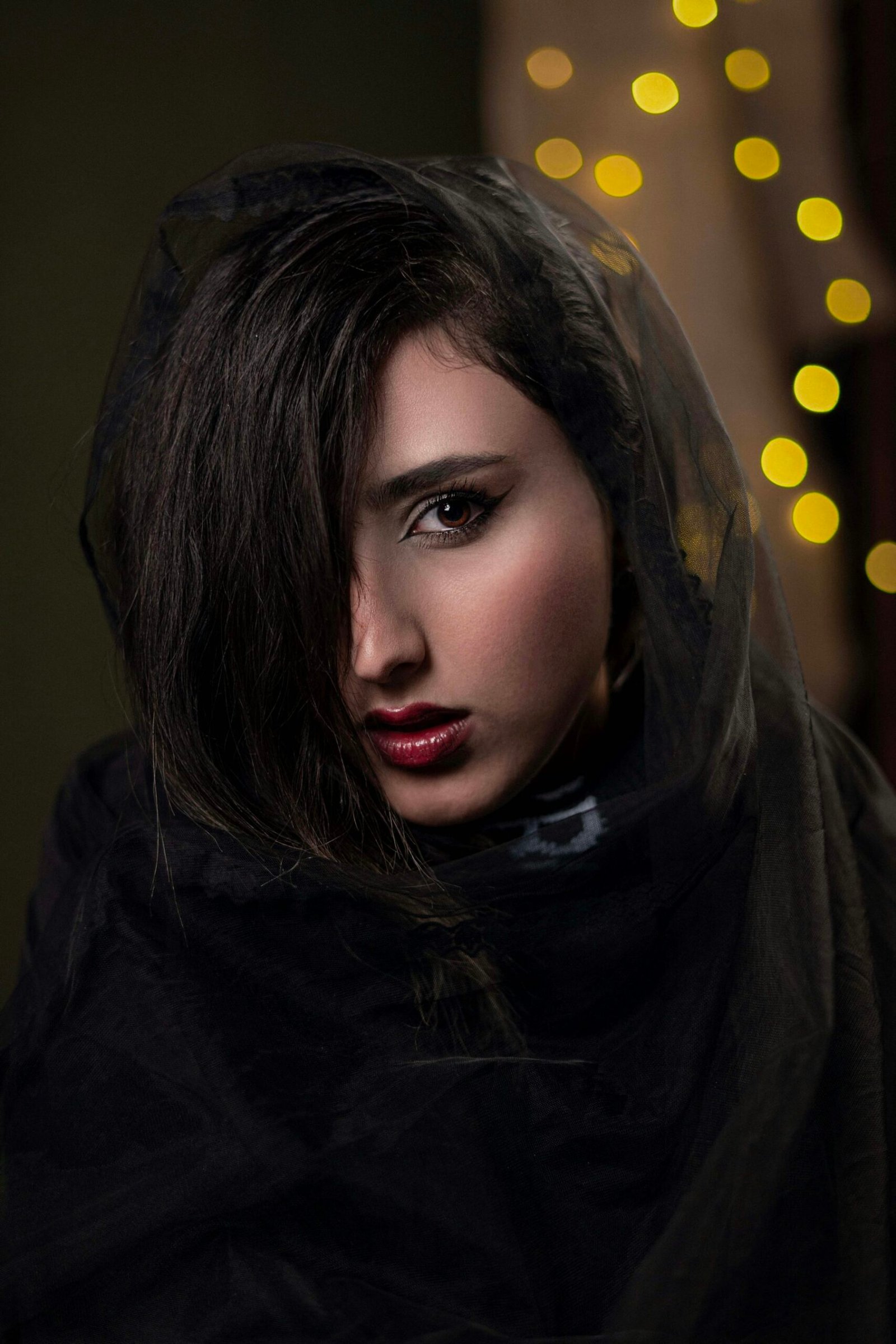 Woman wearing deep berry lipstick with polished makeup