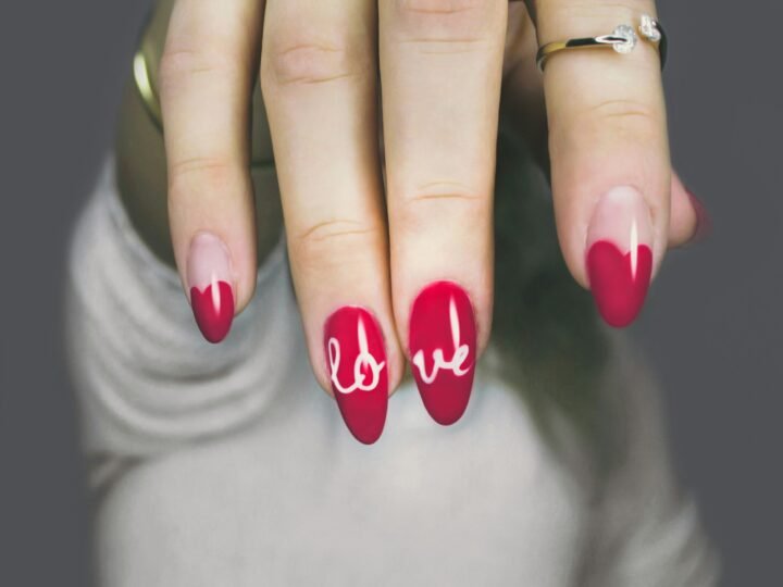 Glossy almond-shaped manicure in deep red and sheer pink tones
