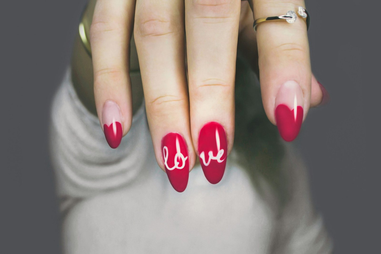 Glossy almond-shaped manicure in deep red and sheer pink tones