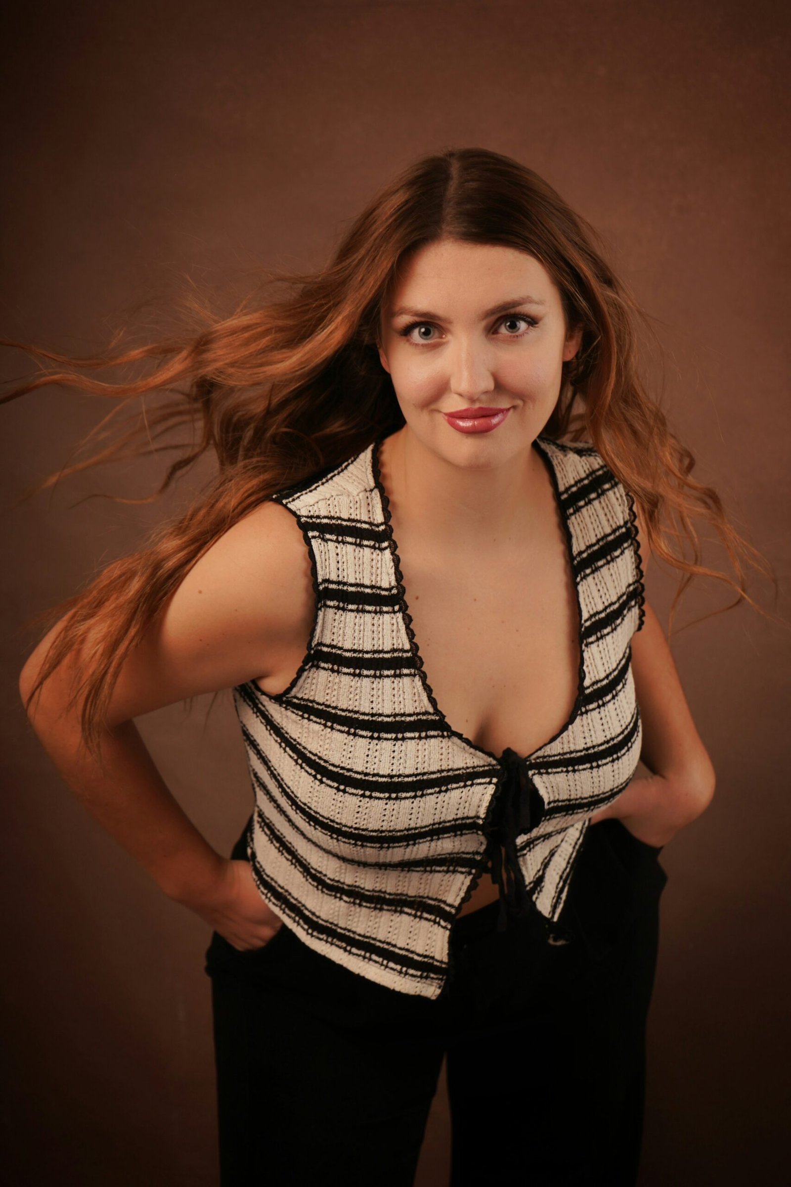 Woman with long flowing brunette hair in a polished beauty portrait