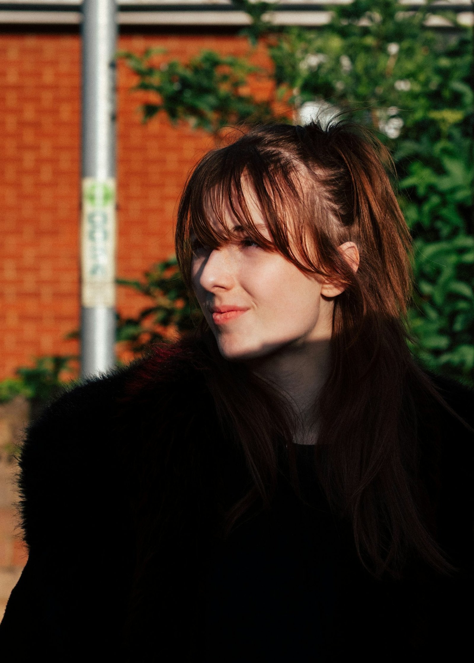 Woman with soft wispy bangs in natural light