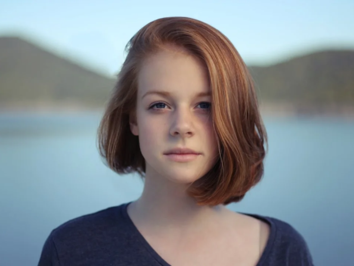 Woman with thick brunette hair and softly shaped face-framing layers