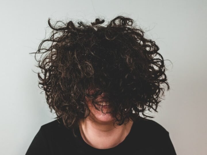 Close portrait with natural curly hair and visible curl movement