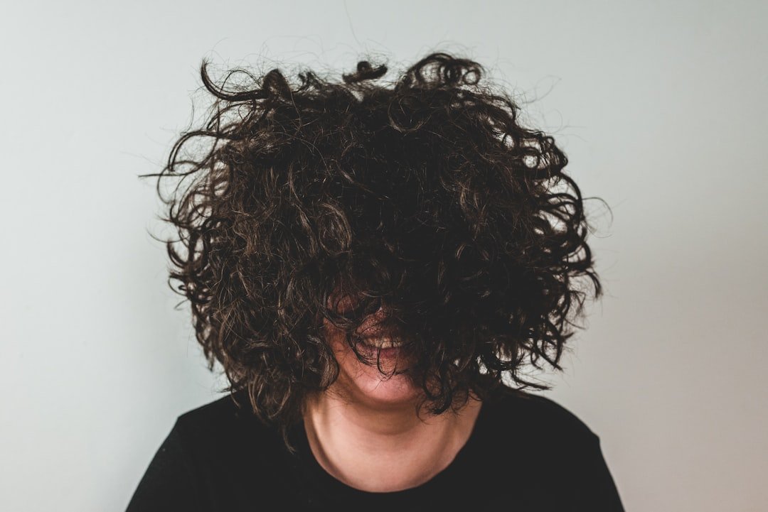 Close portrait with natural curly hair and visible curl movement