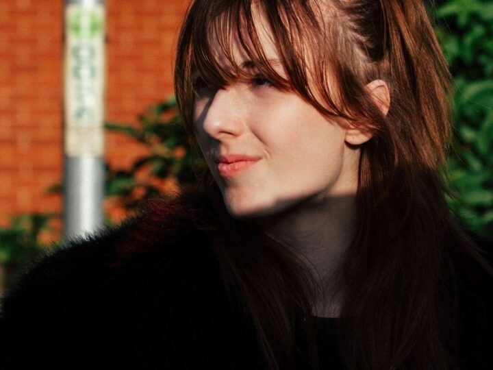 Soft wispy bangs with airy separation across the forehead and light face framing