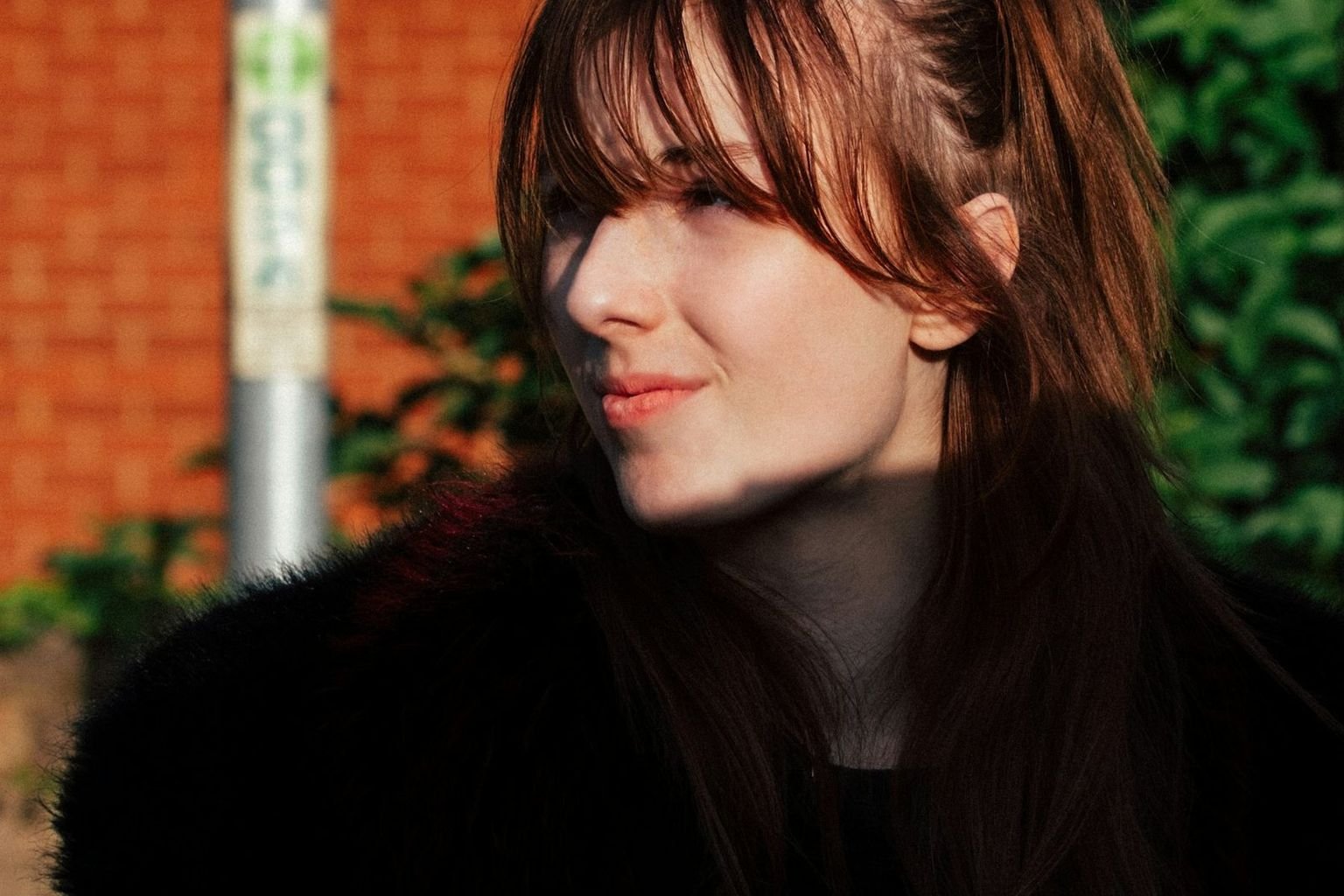 Soft wispy bangs with airy separation across the forehead and light face framing